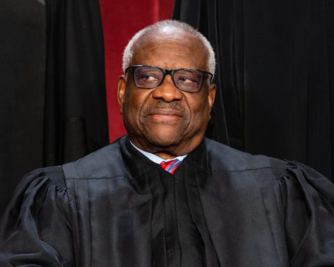 Supreme Court Justice Clarence Thomas in robe, looking to the side during an official portrait session