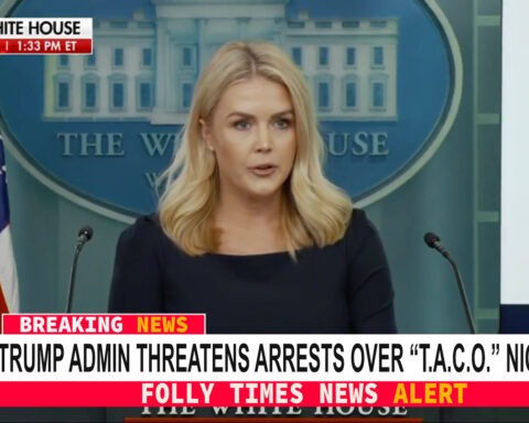 White House Press Secretary Karoline Leavitt speaks at a podium as a breaking news banner declares the Trump administration is threatening arrests over the “T.A.C.O.” nickname