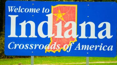 Indiana welcome sign reading “Crossroads of America”