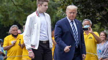 Barron Trump standing on White House steps with Donald Trump during press statement