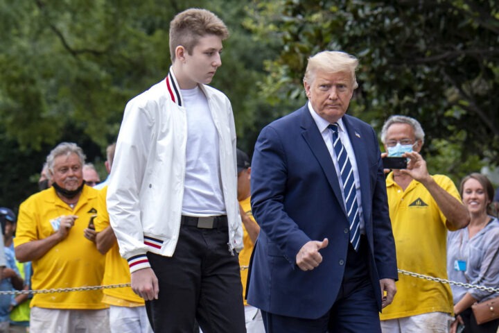 Barron Trump standing on White House steps with Donald Trump during press statement