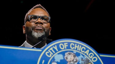 Chicago Mayor Brandon Johnson speaks behind podium about proposed 1% grocery tax.