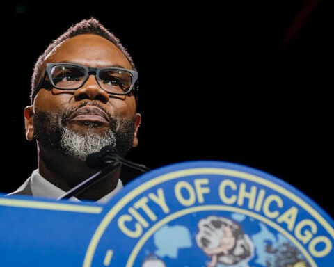 Chicago Mayor Brandon Johnson speaks behind podium about proposed 1% grocery tax.