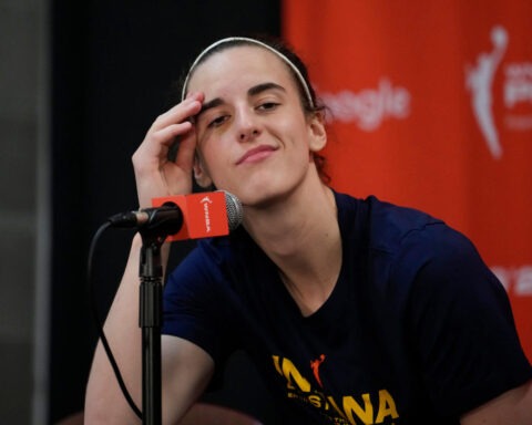 Caitlin Clark smirks at microphone during postgame press conference
