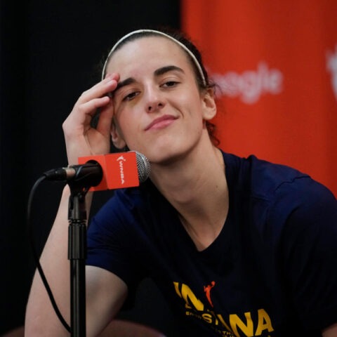 Caitlin Clark smirks at microphone during postgame press conference
