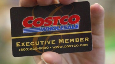 Close-up of a hand holding a black Costco Executive Member card