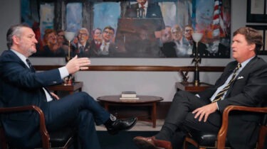 Tucker Carlson interviews Sen. Ted Cruz in front of a Ronald Reagan painting