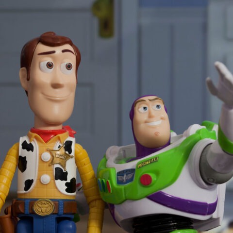 Woody and Buzz Lightyear from Toy Story standing together in a child’s bedroom