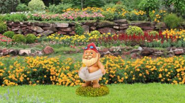 Garden gnome with red hat and unicorn floatie