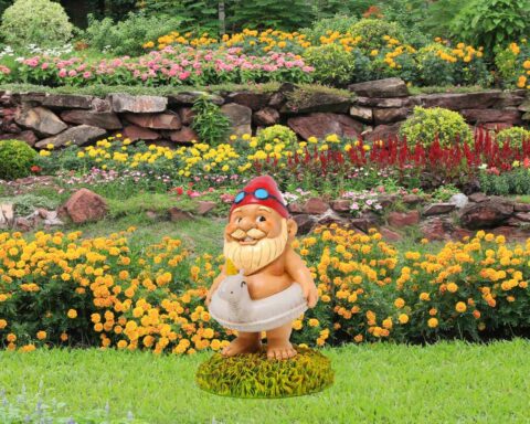 Garden gnome with red hat and unicorn floatie