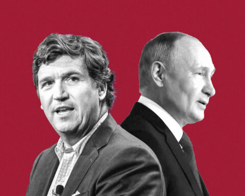 Tucker Carlson and Vladimir Putin seated together in formal meeting
