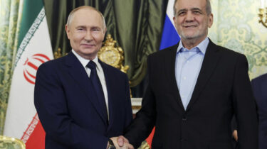Vladimir Putin shakes hands with Iranian President Masoud Pezeshkian during meeting