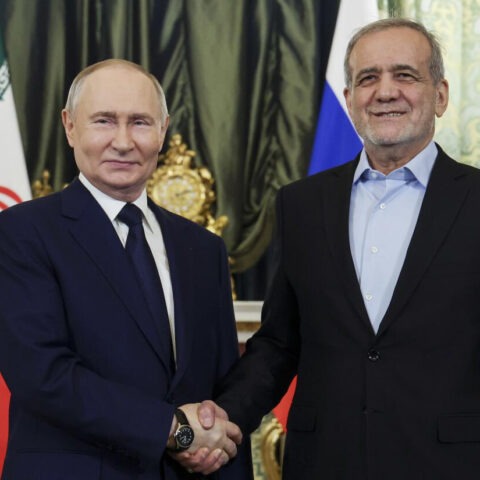Vladimir Putin shakes hands with Iranian President Masoud Pezeshkian during meeting