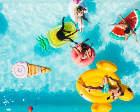 Overhead photo of people in a pool floating on fun floats.