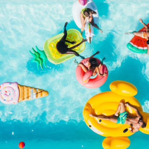 Overhead photo of people in a pool floating on fun floats.