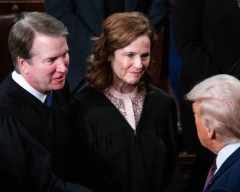 Donald Trump speaking to Supreme Court Justices Amy Coney Barrett and Brett Kavanaugh during a formal event