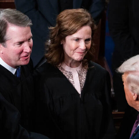 Donald Trump speaking to Supreme Court Justices Amy Coney Barrett and Brett Kavanaugh during a formal event