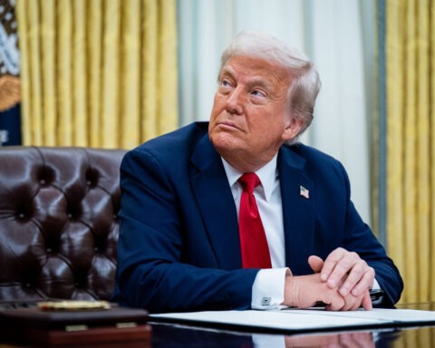 Donald Trump seated in Oval Office launching TruthTrade stock app
