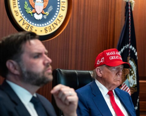 Donald Trump wearing MAGA hat in Situation Room next to JD Vance