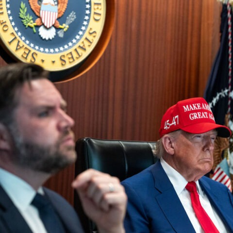 Donald Trump wearing MAGA hat in Situation Room next to JD Vance