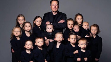 Elon Musk posing with large group of children wearing matching black outfits