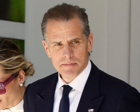 Hunter Biden in suit with woman in sunglasses