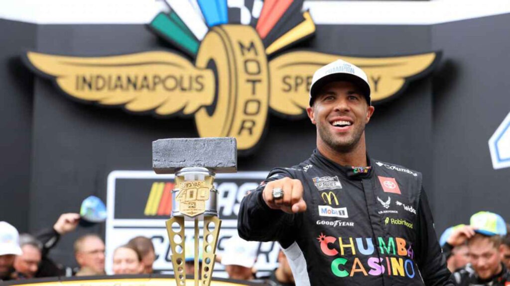 Bubba Wallace pointing with Brickyard 400 trophy after historic NASCAR win