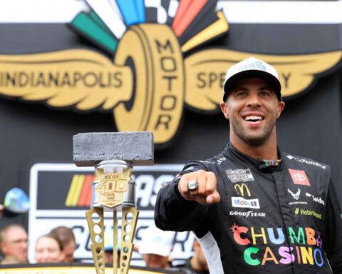Bubba Wallace pointing with Brickyard 400 trophy after historic NASCAR win