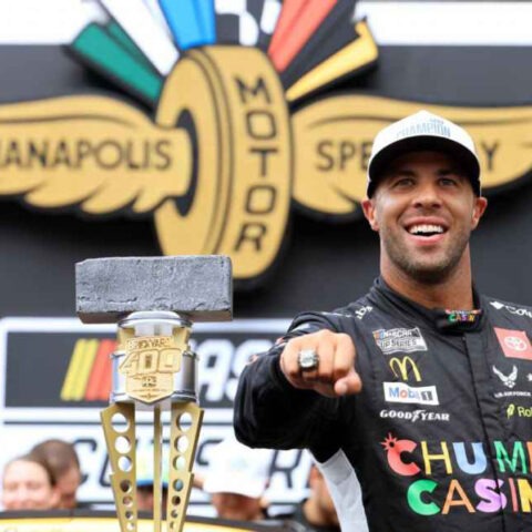 Bubba Wallace pointing with Brickyard 400 trophy after historic NASCAR win