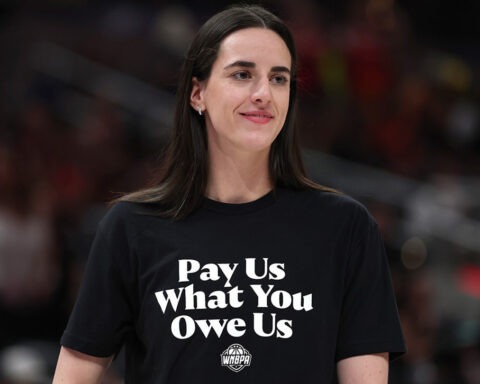 Caitlin Clark wearing shirt that says “Pay Us What You Owe Us” during WNBA All-Star Weekend