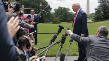President Trump speaks to reporters on White House lawn with Marine One in background