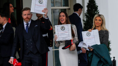 Pam Bondi supporters holding Epstein Files binders outside White House