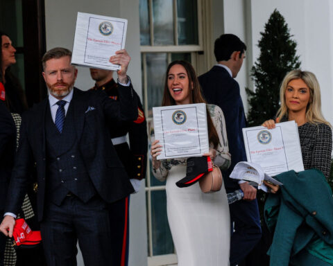 Pam Bondi supporters holding Epstein Files binders outside White House