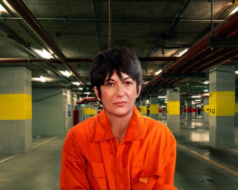 Ghislaine Maxwell in prison jumpsuit standing in underground parking garage