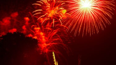 Fireworks exploding in a dry suburban neighborhood