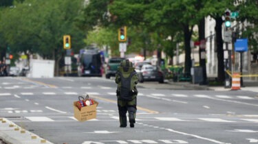 Bomb squad technician approaches suspicious package outside the White House