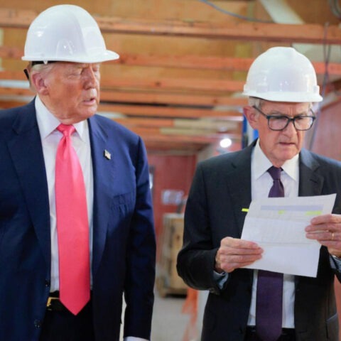 Donald Trump and Jerome Powell in hard hats at Federal Reserve construction site
