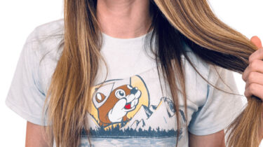 Woman wearing Buc-ee’s t-shirt pulling hair playfully