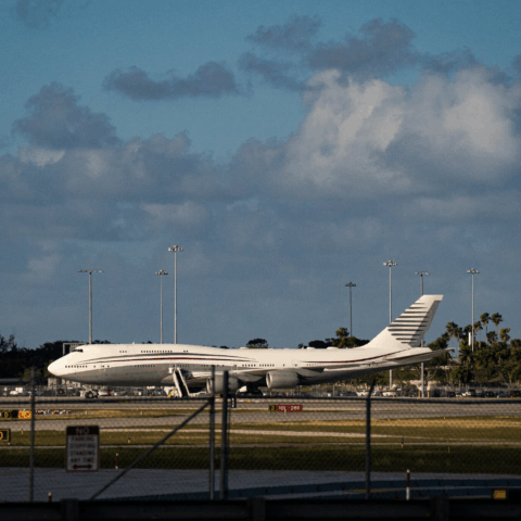 Donald Trump waving next to used Qatari Boeing jet intended as Air Force One
