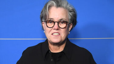 Rosie O'Donnell at press event with blue backdrop