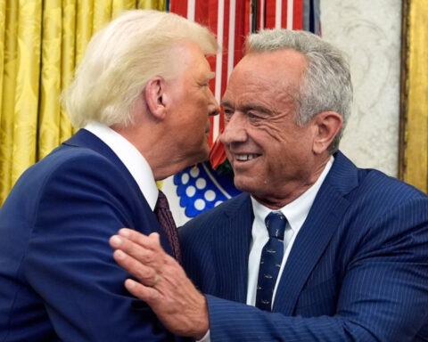 Trump and Robert F. Kennedy Jr. smiling during White House event
