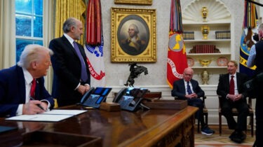 Donald Trump sits at Oval Office desk with Rupert Murdoch and executives
