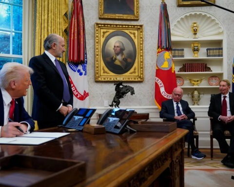 Donald Trump sits at Oval Office desk with Rupert Murdoch and executives