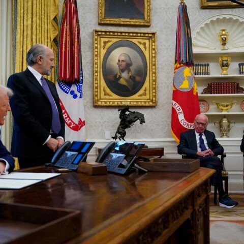 Donald Trump sits at Oval Office desk with Rupert Murdoch and executives