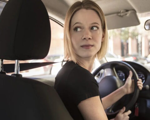 Female Uber driver looking back from driver’s seat