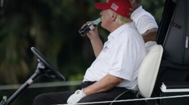 Donald Trump drinking Coca-Cola in a golf cart