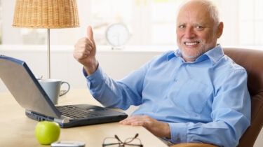 Happy senior man giving thumb up