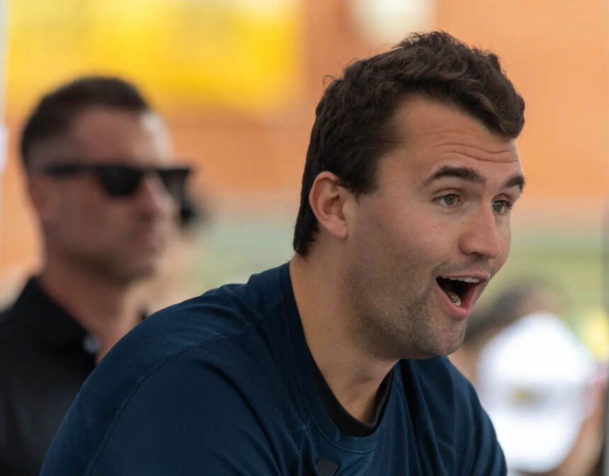 Charlie Kirk speaking outdoors with surprised expression.
