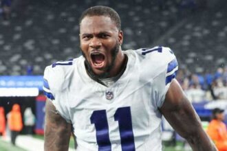 NFL linebacker Micah Parsons shouting in uniform during a game.