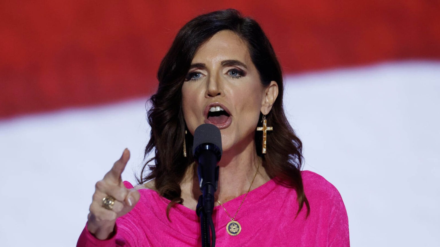 Nancy Mace speaking passionately into a microphone during a political event